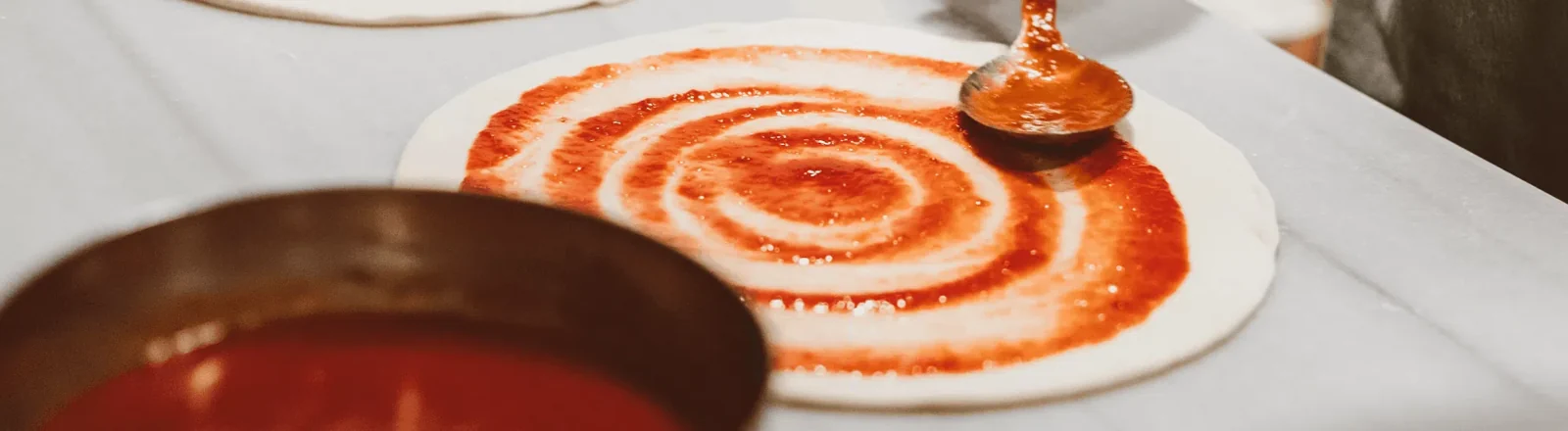 Sauce being spread during food preparation, from the Vikmar Foods website